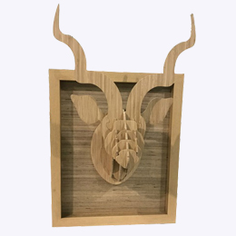 wooden antelope coming out of wooden frame