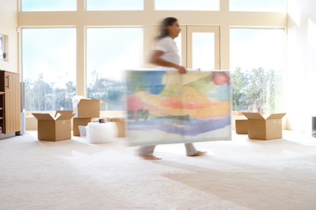 woman moving framed art